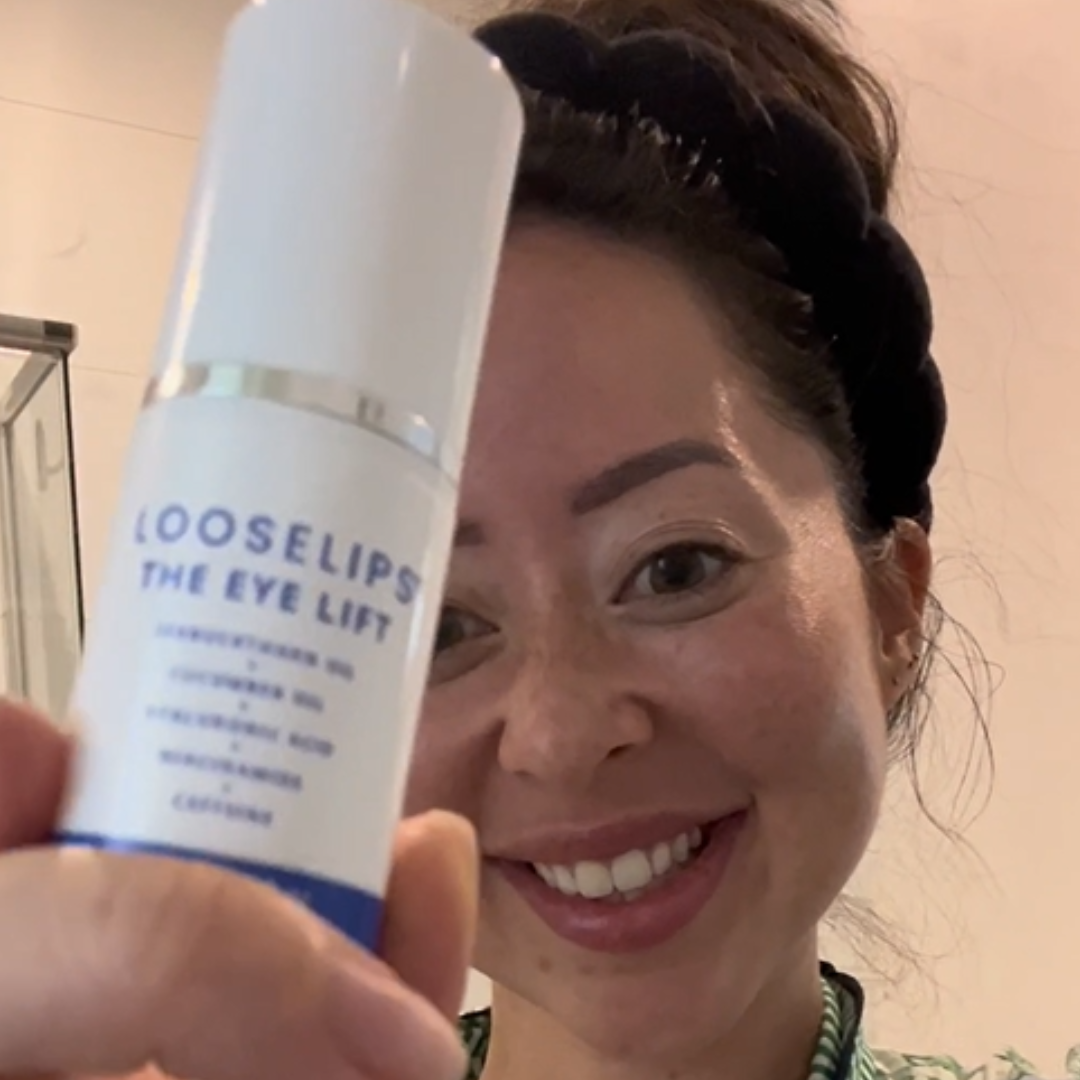 customer holding the looselips eye lift and smiling