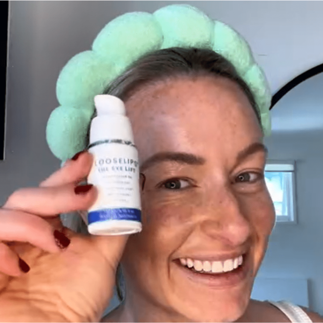 customer holding the looselips eye lift and smiling