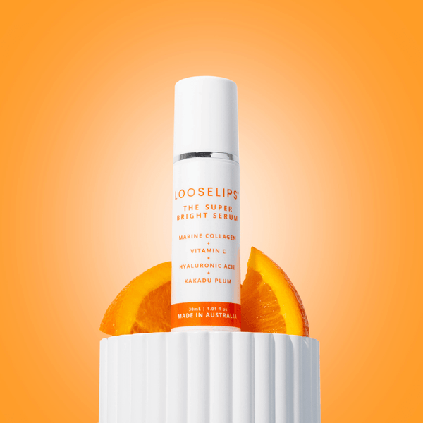 super bright serum against orang background with orange fruit props