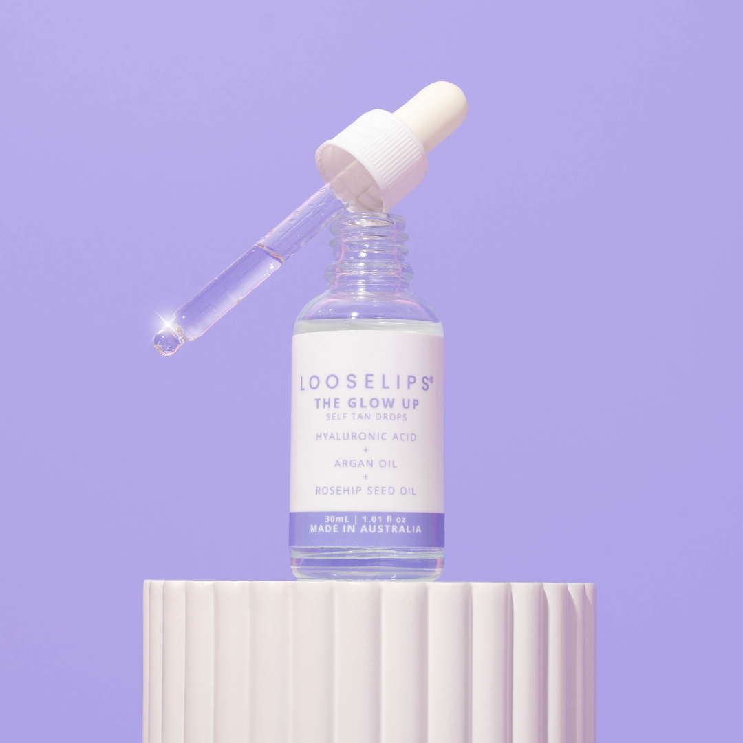 photo of the Looselips Glow Up Self-Tan drops with hyaluronic acid, argan oil and rosehip seed oil against a periwinkle background