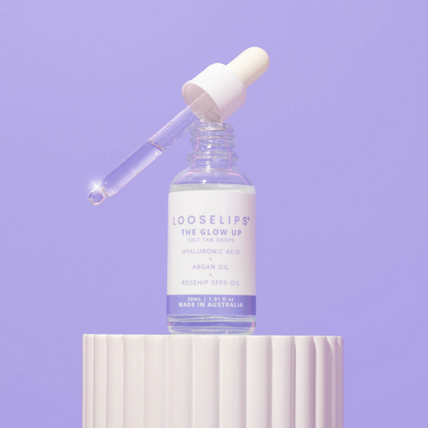 photo of the Looselips Glow Up Self-Tan drops with hyaluronic acid, argan oil and rosehip seed oil against a periwinkle background